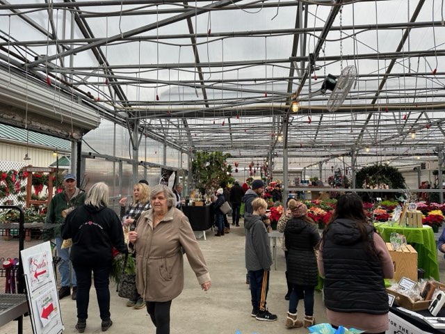 Customers shopping the greenhouse at Troy's